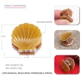 Mini shell-shaped cellulose acetate hair claw clip in amber brown with metal spring - Brown