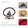 Macro detail of geometric triangle hair tie showing acetate texture and 4.9cm size - Camouflage