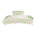 Detail view of large acetate hair claw clip with colorful iridescent green finish and rhinestones - Green