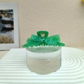 Dettaglio della pinza per capelli in acrilico verde traslucido con fiocco e glitter - Verde