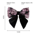 Detail view of purple patterned fabric bow clip with 15cm x 15cm size specifications - Purple