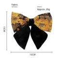 Detail view of jacquard floral bow hair clip with vintage black and gold pattern embroidery - Yellow