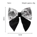 Macro shot of 15cm bow hair clip with vintage silver patterns and velvet details - Gray