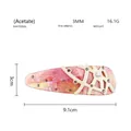 Dettaglio del fermaglio per capelli in acetato rosa con mosaico e rami di cristallo - Rosa a Quadri