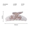 Detail view of large marble acetate hair claw clip with Be Picky rhinestone lettering - Be Picky Style (JY594) / Pearl White And Champagne Rhinestones