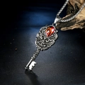 Macro shot of gothic key necklace with red gemstone and intricate floral engravings - Key Red Rhinestone Pendant Only (Without Chain) / Steel Red Zircon