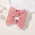 A pair of pink bow hair clips with delicate lace edges on a white display card - Pure Pink