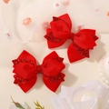 Pair of red bow hair clips for girls with glitter accents and ribbed fabric texture - Red
