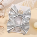 Pair of handmade silver faux leather bow hair clips for kids on a white display card - Silver Style (2A-11R)