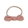 Close-up of pink corduroy bow nylon baby headband with elastic seamless texture - Soft Pink (09)