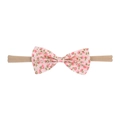 Close-up of baby headband featuring a floral fabric bow and soft nylon elastic band - Pink Floral Bow