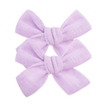 Detail view of two lilac cotton bow hair clips showing soft fabric texture and weave - Pale Purple (10)