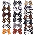 Detailed grid of 18 bow hair clips in leopard print, polka dots, and checkered fabric - Mixed Color Assortment