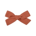 Close-up of rust orange linen fabric bow hair clip with detailed hand-woven texture - Rust Red Style (9)