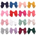 Grille de seize barrettes à nœuds en coton pour filles dans diverses couleurs éclatantes - Multicolore