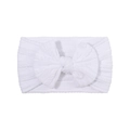 Detail showing soft white ribbed nylon headband for baby with large decorative bow - White