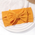 Detail of soft ribbed texture and large bow on ginger yellow baby nylon headband - Ginger (No. 9)