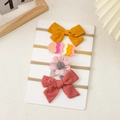 Set of four newborn baby headbands with assorted bows on a white card display - Warm Orange Tone Floral Combination (8)