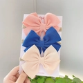 Set of three cute bow headbands for babies in pink, blue, and cream on a display card - Combination Set / Pink Blue Beige