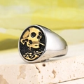 Close-up of retro skeleton ring with gold skull detail on matte black shield base - US 7 / Two-tone (Gold & Silver)