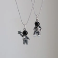 Detail of vintage astronaut pendants with star motifs and black enamel masks on bead chains - Star Catching Astronaut And Star Holding Astronaut / Bead Chain