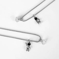 Magnetic astronaut couple necklaces in silver finish with black enamel and star details - Astronaut Pair