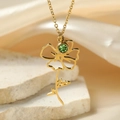 Detailed close-up of golden floral pendant with green crystal on elegant stone background - August Flower