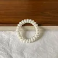Fresh white spiral telephone wire hair tie featuring vibrant colorful polka dots pattern - White Peach