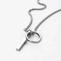 Macro shot of silver stainless steel geometric bar pendant on a sleek box chain necklace - Silver