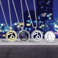 Capricorn zodiac necklaces in gold, black, and silver finishes beside a quarter coin - Capricorn / Silver