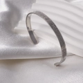 Silver stainless steel C-shaped cuff bracelet featuring a textured hammered metal surface - Rune Style (Silver)