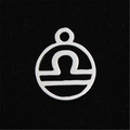Macro shot of silver Libra constellation pendant in stainless steel with hollow design - Libra