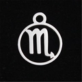 Macro shot of Scorpio zodiac pendant in polished stainless steel on black velvet - Scorpio