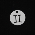 Macro detail of silver stainless steel Gemini zodiac sign pendant with hollow design - Gemini