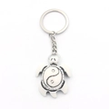 Yin Yang Tai Chi sea turtle alloy keychain with vintage silver finish on white background - White