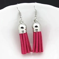 Detailed view of vibrant fuchsia suede tassel earrings with polished silver metal caps - Fuchsia (H)