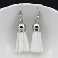 Detail of white suede fringe earrings with silver metal hooks on a porcelain edge - White (f)