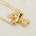 Vintage golden necklace with polished fluid cross pendant on elegant beige background - Smooth Cross / Gold