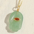 Hamsa hand necklace with light green gemstone and red eye detail on golden chain - Green Palm