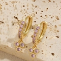 Boucles d'oreilles dorées avec grappes de zircones roses sur fond de travertin - Zircon Rose
