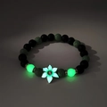 Luminous bead bracelet with dark grey lava stones and silver floral pendant in the dark - Green