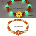 Macro shot of luminous orange sunflower bracelet showing daylight and night glow effect - Orange-Red Glow