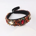 Close-up of luxury Baroque headband with colorful crystals and gold metal flower details - Red and Orange (F)