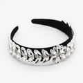 Detailed macro view of baroque crystal headband featuring silver flower and leaf patterns - White
