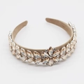 Detail of baroque headband featuring amber crystals and champagne gold floral leaf design - Yellow