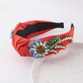 Detail of orange knotted headband featuring handcrafted blue crystal flowers and beadwork - Red