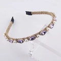 Macro shot of gold braided metal headband with lavender crystals and white pearls - Purple