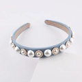Detail view of the blue fabric headband featuring large pearls with gold bead accents - Light Blue
