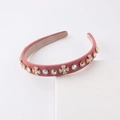 Detail of rose pink velvet Alice band featuring AB rhinestones and golden bow accents - Dried Rose