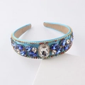 Baroque sky blue headband with blue gemstones and crystals on a white pedestal - Blue
